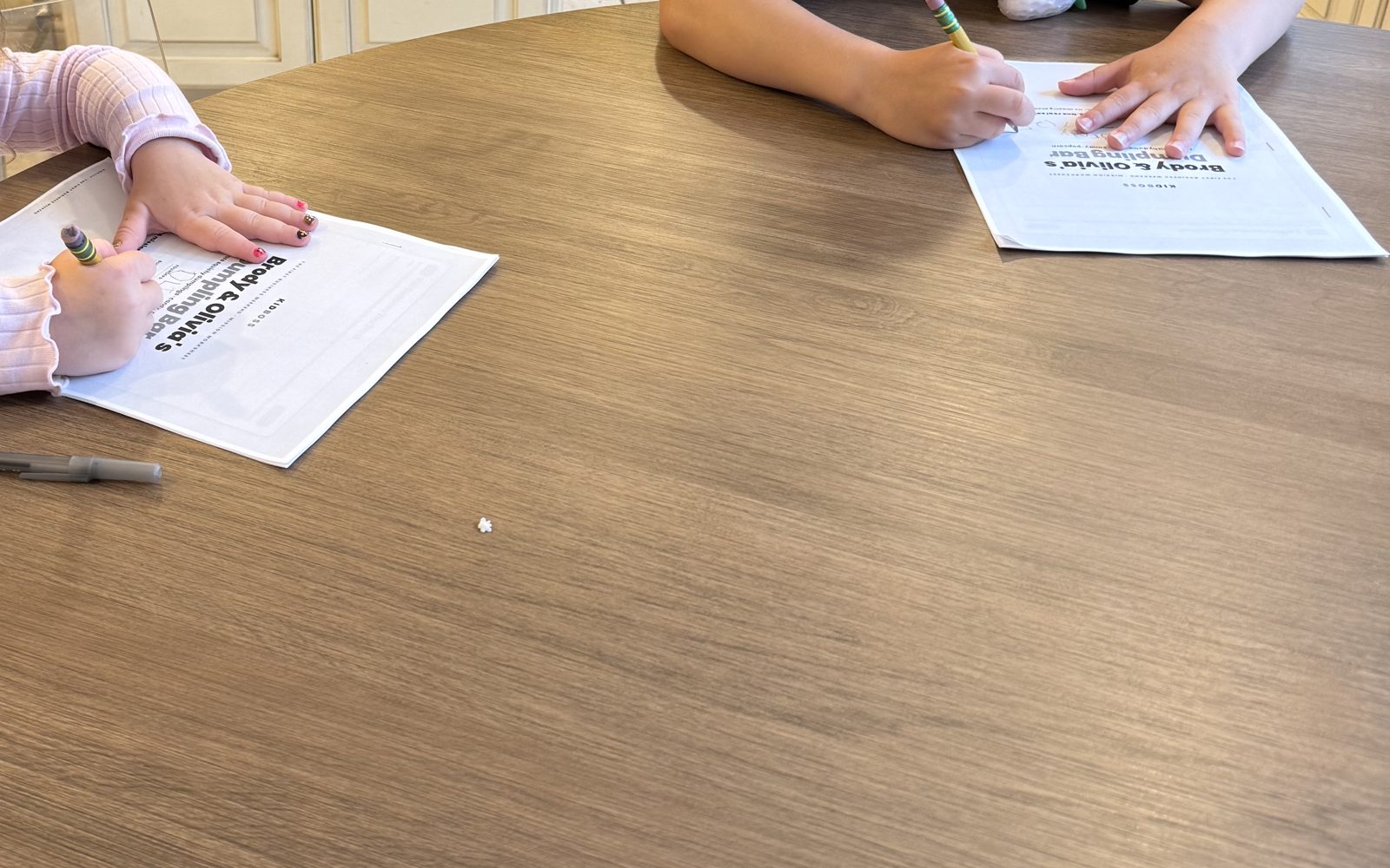 Kids testing KidBoss worksheets at the kitchen table